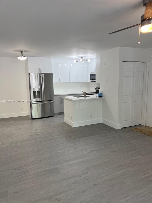 kitchen featuring sink, white cabinetry, appliances with stainless steel finishes, hardwood / wood-style flooring, and ceiling fan