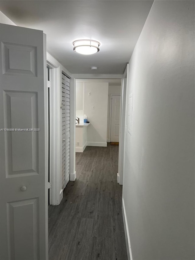 corridor featuring dark hardwood / wood-style floors