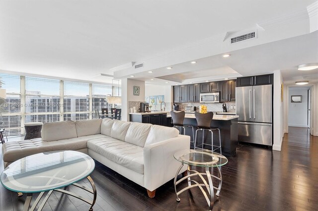 800 Parkview Dr Unit 1014, Hallandale Beach, FL 33009 - living room with a raised ceiling, ornamental molding, dark wood-style floors, and visible vents
