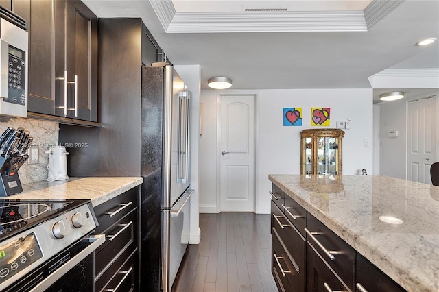 kitchen featuring crown molding, stainless steel appliances, light stone countertops, and decorative backsplash