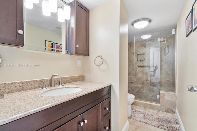 800 Parkview Dr Unit 1014, Hallandale Beach, FL 33009 - bathroom with baseboards, a stall shower, toilet, and vanity