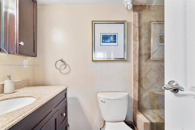 bathroom with vanity, toilet, and a shower with door