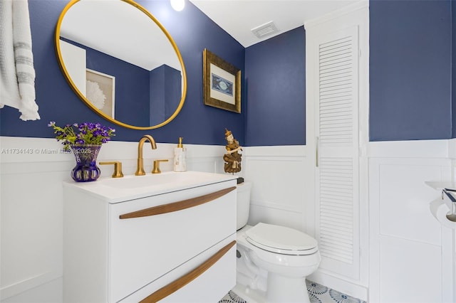 bathroom featuring vanity and toilet