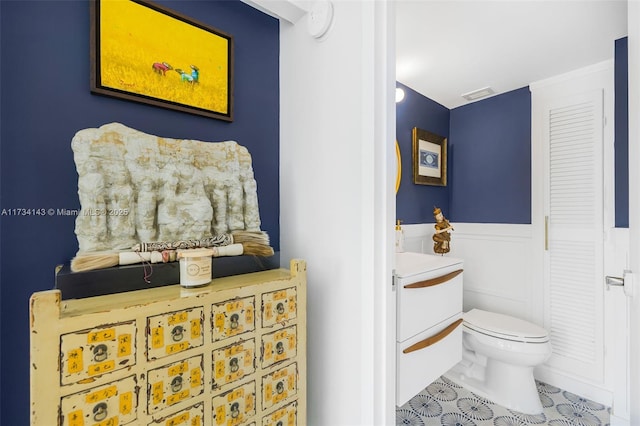 bathroom with vanity, toilet, and tile patterned flooring