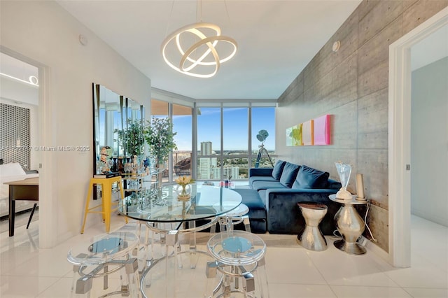 living room with light tile patterned flooring, a notable chandelier, and a wall of windows