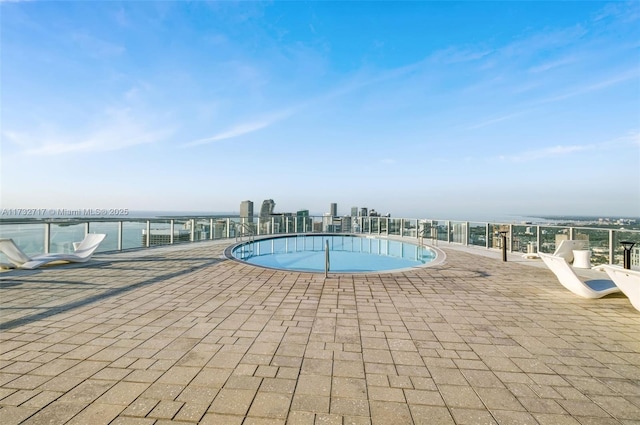 view of swimming pool with a water view