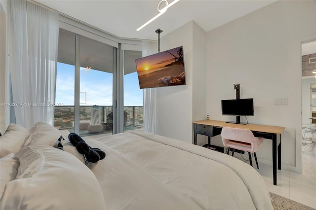 bedroom with expansive windows and access to outside