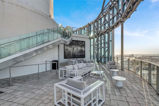 patio terrace at dusk featuring a balcony and outdoor lounge area