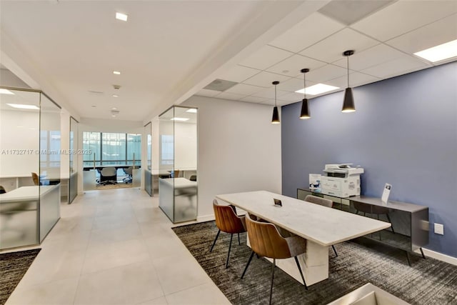 tiled dining space featuring a paneled ceiling