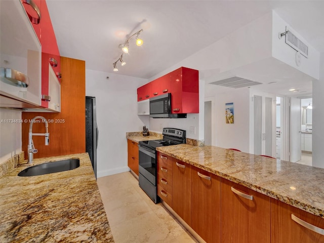 kitchen featuring light stone counters, stainless steel appliances, rail lighting, and sink