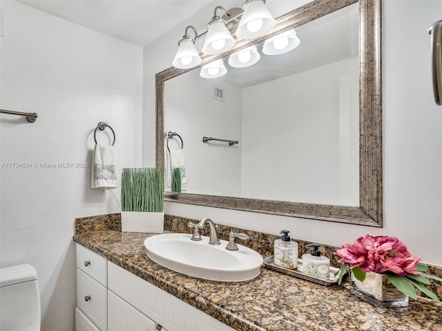 bathroom with vanity and toilet