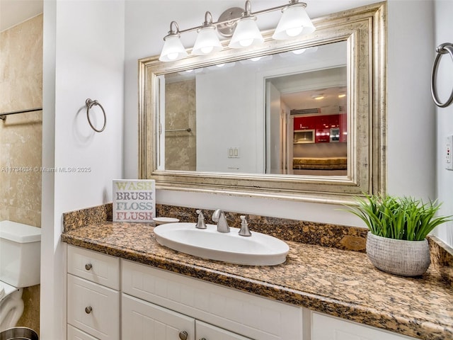 bathroom with vanity and toilet