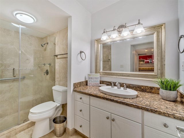 bathroom with walk in shower, vanity, toilet, and tile patterned flooring