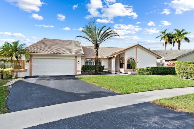 view of front of property featuring a garage and a front yard