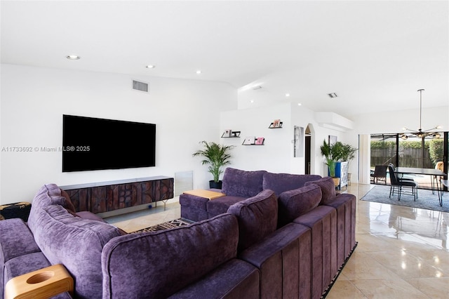 living room with lofted ceiling, a chandelier, and light tile patterned flooring