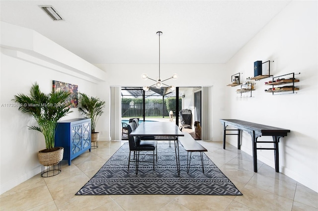 dining room featuring light tile patterned floors and a chandelier