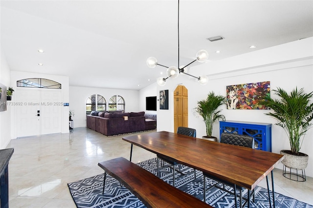 tiled dining area with vaulted ceiling