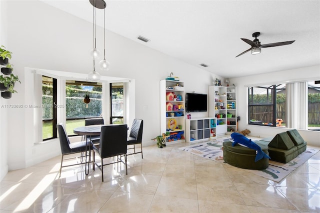 tiled living room featuring high vaulted ceiling and ceiling fan