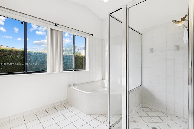 bathroom featuring lofted ceiling, tile patterned floors, and independent shower and bath