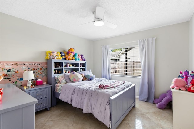 tiled bedroom with ceiling fan and a textured ceiling