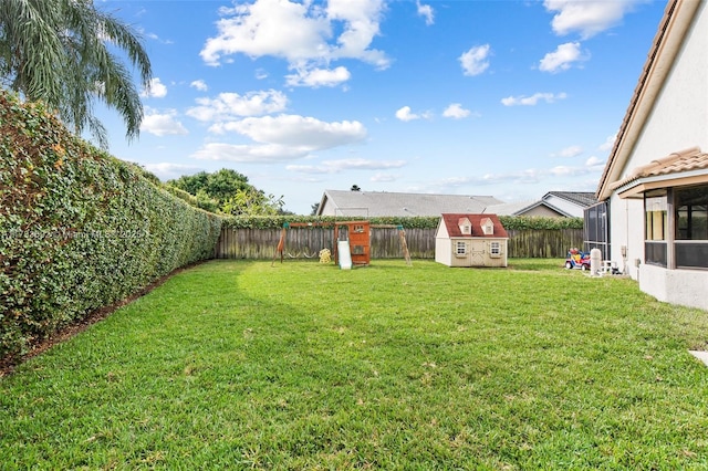 view of yard featuring a playground and a shed