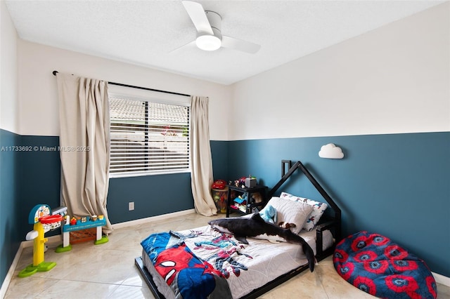 tiled bedroom with a textured ceiling and ceiling fan