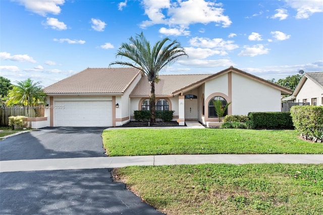 view of front of house with a garage and a front lawn