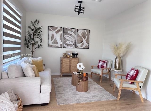 living area with hardwood / wood-style floors and a wealth of natural light