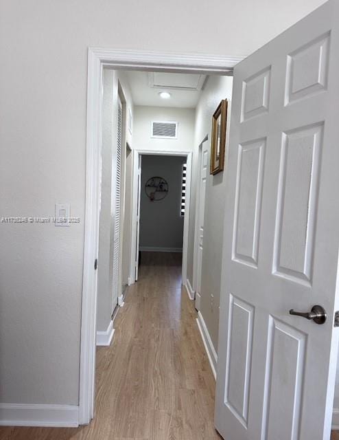 corridor with light wood-type flooring