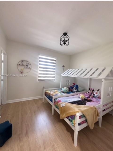 bedroom with hardwood / wood-style floors