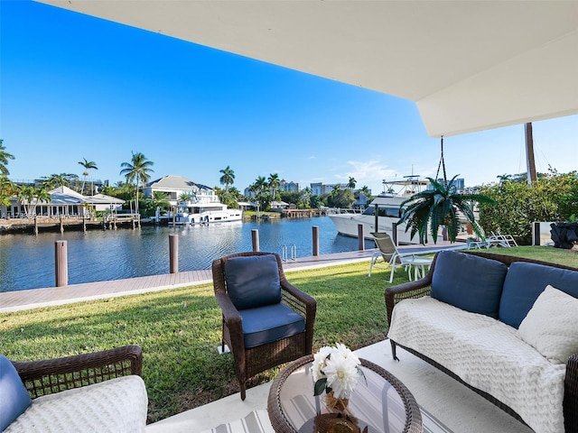 view of yard with a water view, outdoor lounge area, and a boat dock