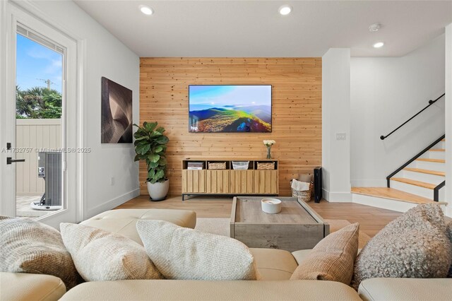 living room featuring wooden walls and light wood-type flooring