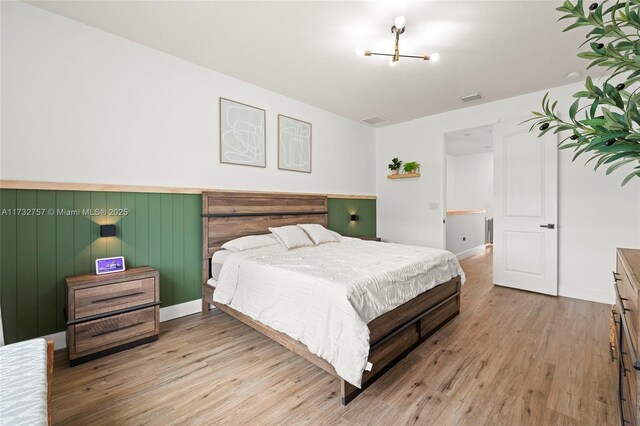 bedroom with light hardwood / wood-style flooring