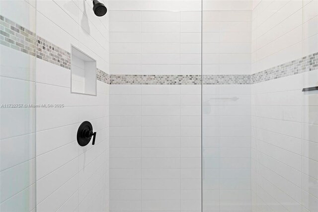 bathroom with a tile shower