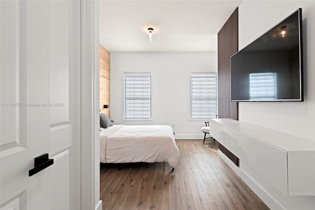 bedroom featuring hardwood / wood-style flooring and a textured ceiling