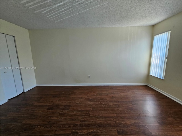 unfurnished bedroom featuring dark hardwood / wood-style floors and a textured ceiling