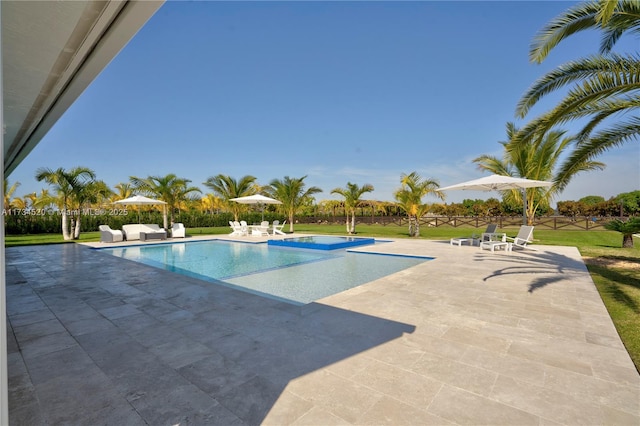 view of pool featuring a yard and a patio area