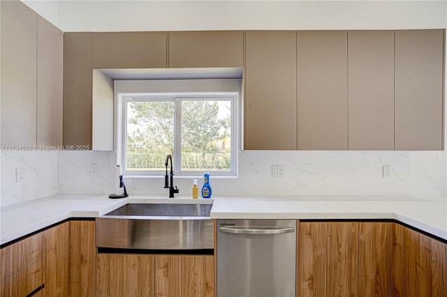 kitchen with tasteful backsplash, stainless steel dishwasher, light stone countertops, and sink