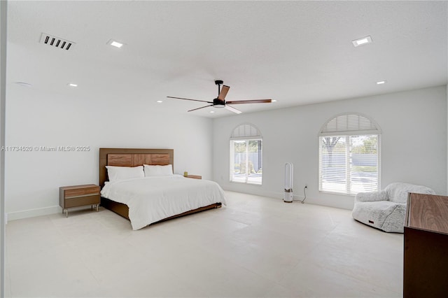 bedroom with ceiling fan and a textured ceiling