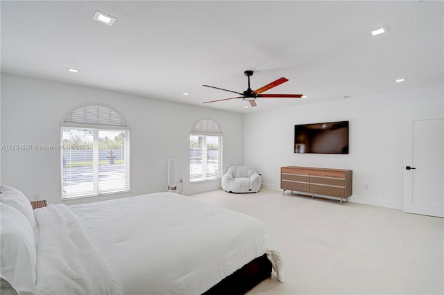 carpeted bedroom featuring a textured ceiling and ceiling fan