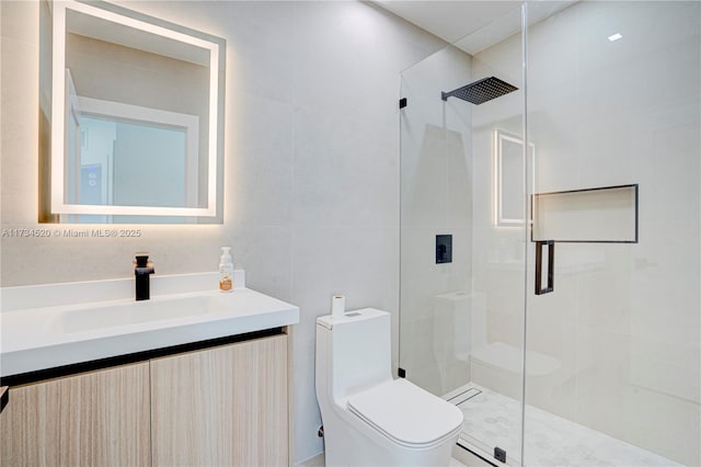 bathroom with vanity, tile walls, an enclosed shower, and toilet