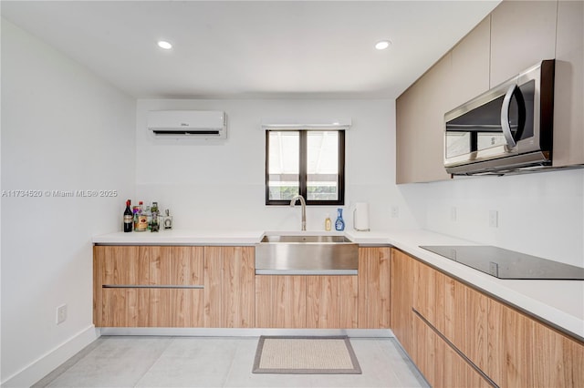 kitchen featuring light tile patterned flooring, sink, a wall mounted AC, light brown cabinets, and black electric stovetop