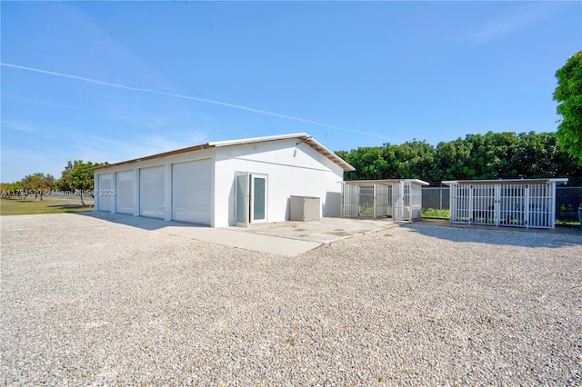 exterior space with an outbuilding and a garage