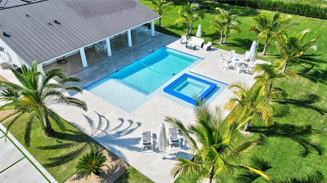 view of pool with a patio area and an in ground hot tub