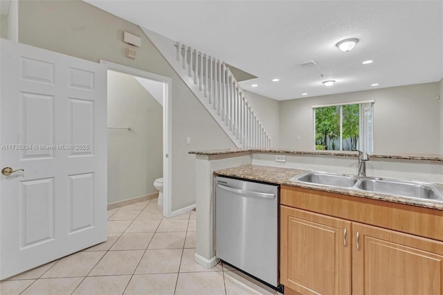 kitchen featuring light tile patterned flooring, sink, and stainless steel dishwasher