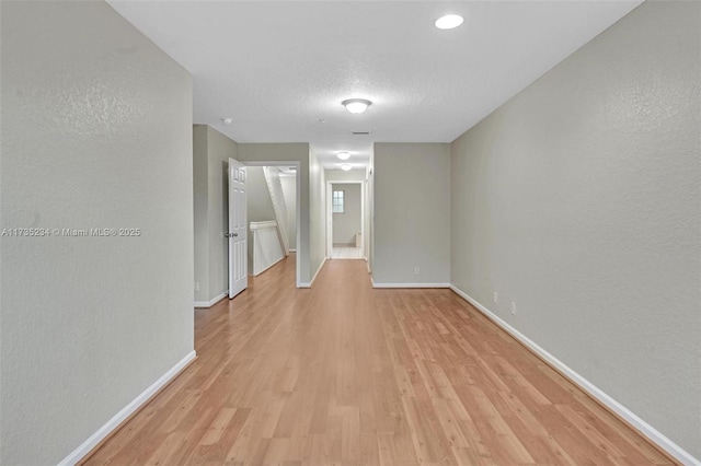 interior space featuring a textured ceiling and light hardwood / wood-style flooring