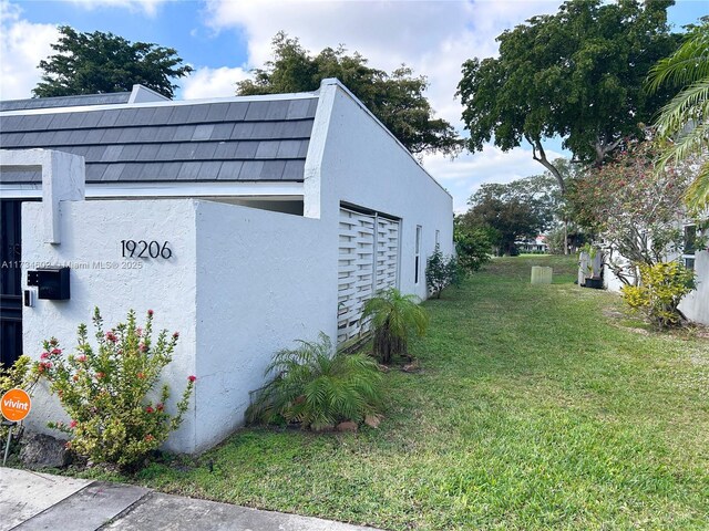 view of property exterior featuring a yard