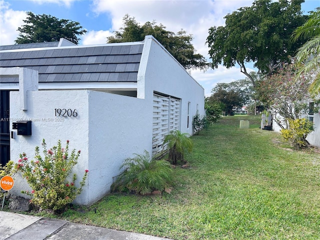 view of side of property with a yard