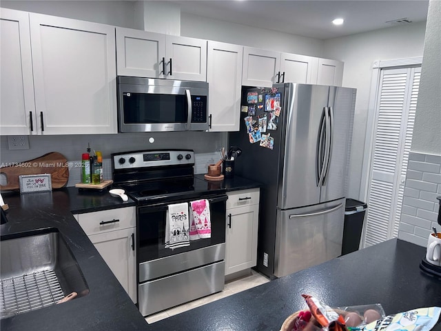 kitchen featuring white cabinetry, appliances with stainless steel finishes, and sink