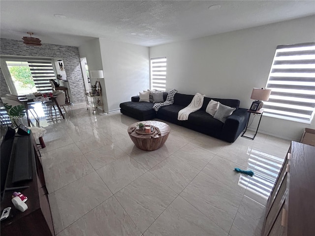 living room featuring a wealth of natural light and a textured ceiling